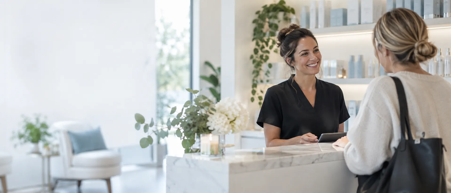 Skincare studio receptionist welcoming a client